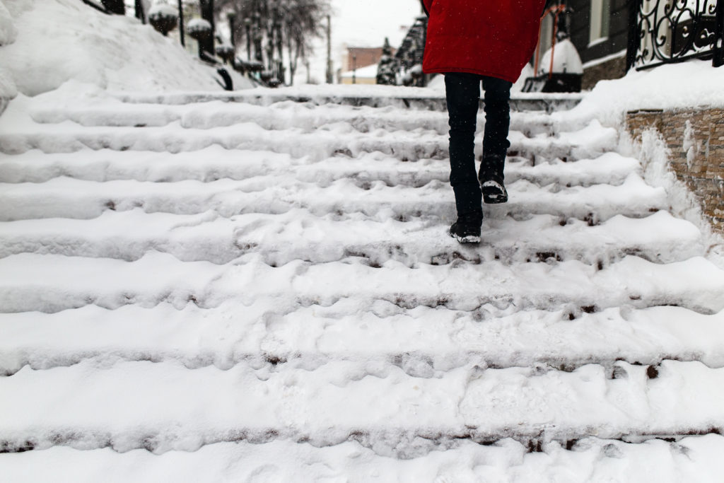 Woman Climbs Stairs in the Snow